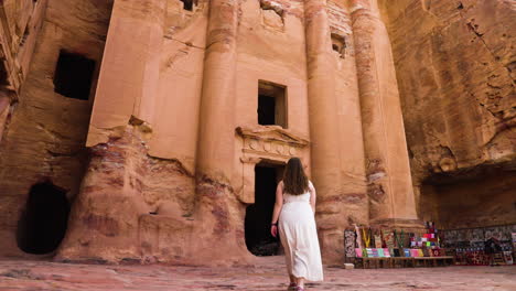 Female-Traveler-Walking-Towards-The-Treasury-In-The-Ancient-City-Of-Petra-In-Jordan