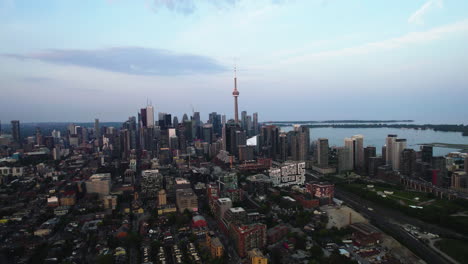 Aerial-view-backwards-over-the-Niagara-district-of-Toronto,-summer-evening-in-Canada