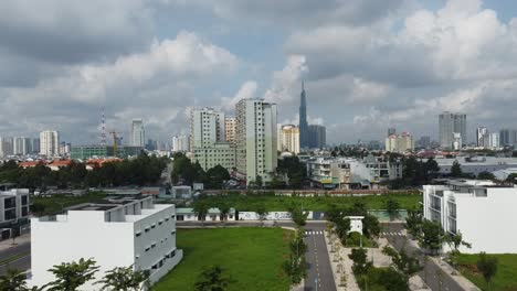 Drone-shot-of-residential-district-2-neighborhood-of-Ho-Chi-Minh-City,-Vietnam-with-downtown-district-1-in-distance-on-a-sunny-morning-with-a-cloudy-sky