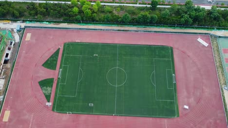 Cinematic-aerial-ascending-tilt-up-view-of-a-soccer-football-field