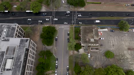 Overhead-drone-video-view-of-street-in-Austin,-Texas-to-tilt-up-of-Texas-state-capitol-building