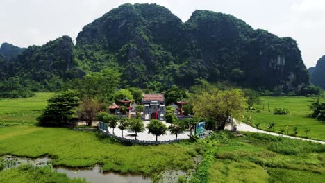 Drone-Approaching-Thai-Vi-Temple-in-Ninh-Binh,-Vietnam-at-Low-Altitude-on-a-Sunny-Day
