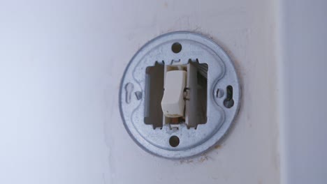 Person-Turning-Off-The-Light-Switch-Before-Leaving-The-House