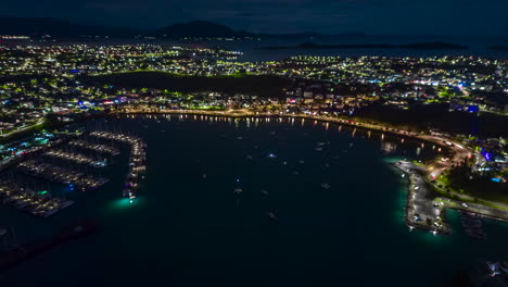 Night-aerial-timelapse-over-Orphanage-Bay,-nightlife-in-Noumea,-New-Caledonia