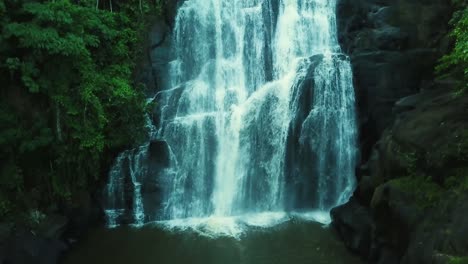 Ascending-slow-motion-aerial-shot-revealing-beautiful-big-waterfall-in-woods