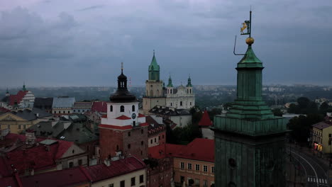 Aerial-view-of-colorful-tenement-houses,-town-hall-and-town-towers-in-Old-Town-in-Lublin,-Poland-during-stormy-weather