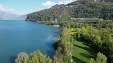 Blend-of-beautiful-blue-waters,lush-greenery-at-Klontalersee-lake,aerial