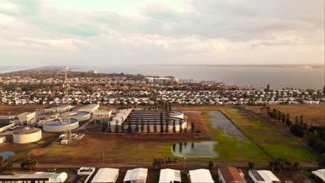 a-slow-aerial-shot-of-houses-and-homes-in-Melbourne-Florida-with-the-ocean-water-near-by-and-a-cloudy-sky-above