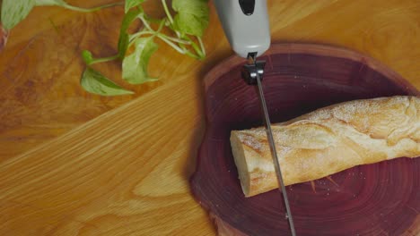 Slicing a bread loaf with an electric knife 