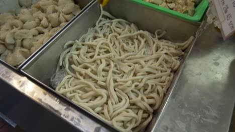 Seafood-fish-cake-noodle-at-street-food-market-booth-court-for-sale-documentary