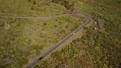 Curvy-road-in-mountain-area-of-Tenerife-island,-aerial-orbit-view