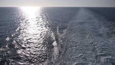 Open-ocean-view-from-a-ship-with-sunshine-and-foam-waves