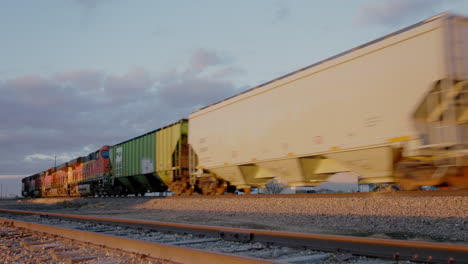 Freight-Train-Passing-Through-American-Farmland-at-Sunset