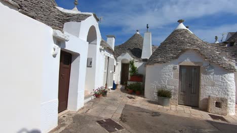 Traditionelle-Häuser-Des-Kulturerbes-Von-Alberobello-Und-Ein-Junger-Mann