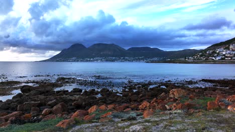 Aerial-cinematic-drone-Simons-Town-Cape-Town-train-track-ocean-coastline-over-reef-seaweed-early-sunrise-South-Africa-Fish-Hoek-naval-marina-bay-whale-dolphins-slowly-forward-movement