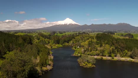 Natural-wonder-of-Taranaki-volcano-and-amazing-New-Zealand-landscape-with-lake-and-native-forest---drone-pull-back
