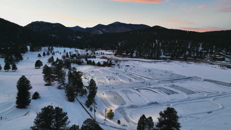 Mid-winter-Colorado-sunset-golden-hour-Evergreen-Lake-under-lights-playing-hockey-at-various-rinks-cinematic-circle