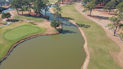 Aerial-flyover-empty-Myrtlewood-Golf-course-with-lake-during-sunny-day-in-Myrtle-beach