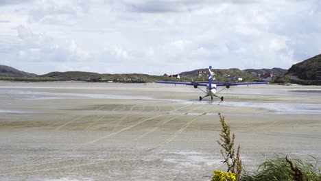 Shot-of-a-plane-taxiing-along-the-beach-at-Barra-airport---the-worlds-only-tidal-airport-using-the-beach-as-a-runway