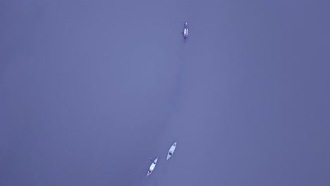 Overhead-Drone-Shot-of-Canoes-in-body-of-Water