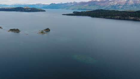 Aerial-Tilt-Up-From-View-Of-Calm-Scenic-Nahuel-Huapi-Lake-To-Reveal-Expanse-Of-Lake-Waters