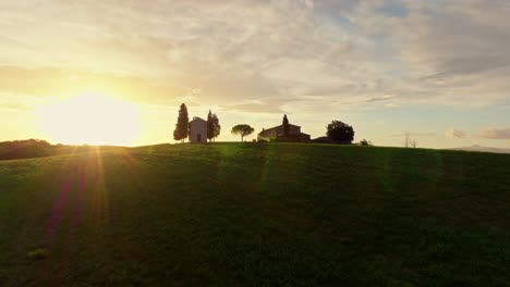 Aerial-of-the-Chapel-of-the-Madonna-di-Vitaleta-at-sunrise,-Province-of-Siena,-Italy