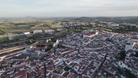 Town-of-Elvas,-green-landscape-and-distant-horizon-in-Portugal,-aerial