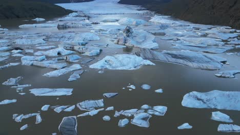 Rising-Aerial-View-of-Icebergs-in-Calving-Glacier-Lake