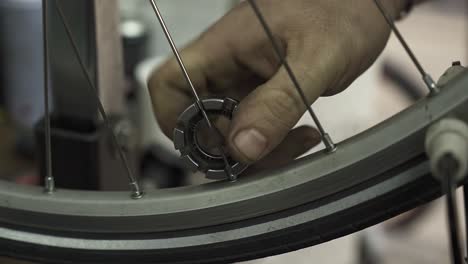 A-bicycle-mechanic-aligning-a-bicycle-wheel