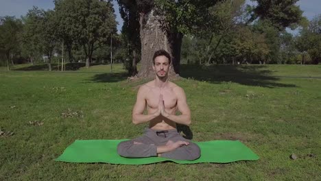 Caucasian-young-slim-sporty-man-doing-yoga-exercise