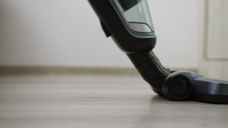 Vertical-vacuum-cleaner-with-LED-light-used-on-laminated-floor