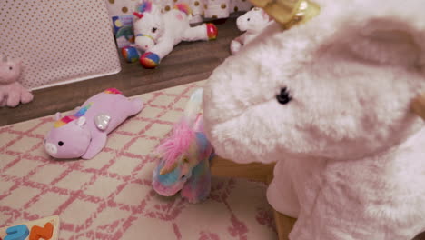 Rocking-Unicorn-in-Messy-Little-Girl's-Room-With-Stuffed-Animals-Childhood