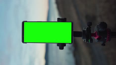 Vertical---Smartphone-With-Green-Screen-Mounted-On-Tripod-Stand-Outdoor