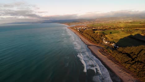Waitoha-Beach-aerial-pull-back-reveal-of-Opotiki-landscape-during-golden-hour