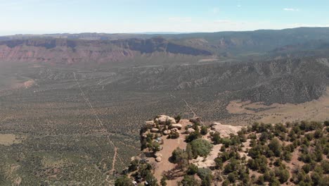 Aerial-retreats-from-canyon-rim-campsite-high-above-Castle-Valley-Moab