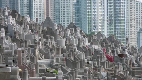 View-of-hundreds-of-tombstones-at-a-crowded-cemetery-as-residential-buildings-are-seen-in-the-background
