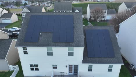 Close-up-aerial-shot-of-solar-panel-array-on-roof-of-large-American-home