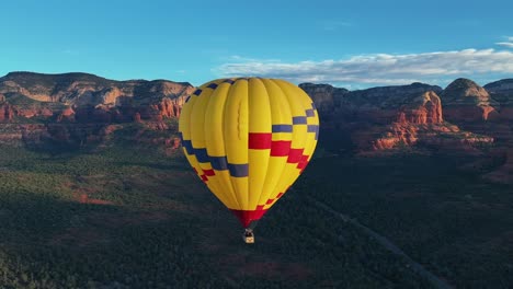 Yellow-Hot-Air-Balloon-In-Sedona,-Arizona---aerial-drone-shot