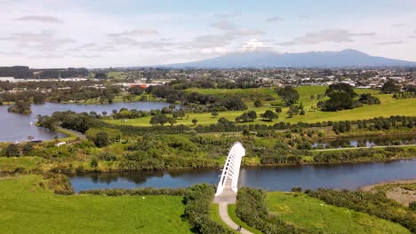 Aerial-View-Of-Popular-Te-Rewa-Rewa-Bridge-With-Unique-Architectural-Design-Over-The-Waiwhakaiho-River-In-New-Plymouth,-New-Zealand