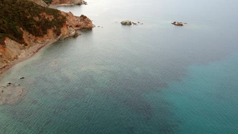 Sardaignan-shore-and-sea-diving-view-from-a-drone-by-sunset