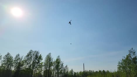 firefighter-helicopter-in-the-sky-Air-Force-Heli-copter-getting-water-from-a-pond-lake,-Helps-Firefighters-Extinguishing-an-Extensive-Forest-Fire
