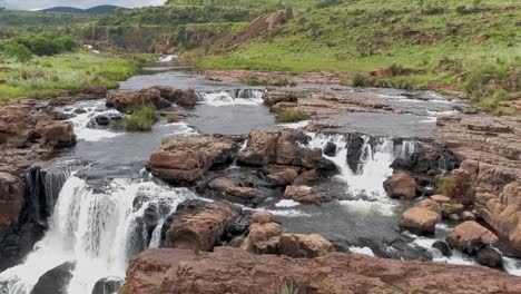 Aerial-HD-slow-motion-50fps-drone-footage-of-the-surrounding-landscape-and-small-waterfalls-along-the-Blyde-River-in-Graskop,-Mpumalanga,-South-Africa