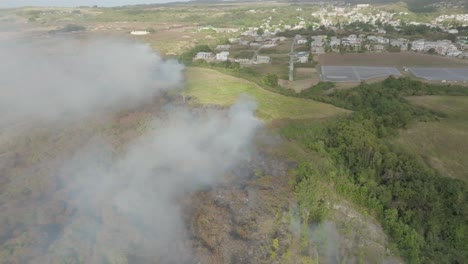 Drone-shot-of-smoke-from-a-forest-fire-on-an-island
