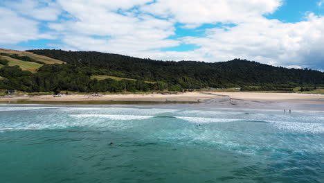 Aerial-panorama-of-paradise-surfing-spot-and-beach-at-Parakaunui-bay-New-Zealand