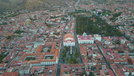 Aerial-drone-view-flying-down-toward-a-plaza-square-in-Sucre,-Bolivia