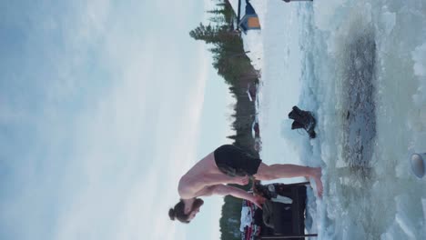 Vertical---Topless-Barefoot-Man-Walking-On-Frozen-Lake-To-Pick-Up-His-Clothes