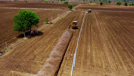 Aerial-Camera-moving-above-the-excavation-water-pipe-and-large-water-system-underground-at-farm
