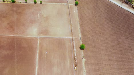 Aerial-tilt-shot-of-fittings-pipeline-at-large-scale-on-the-agricultural-farm-at-hot-summer-time-in-India