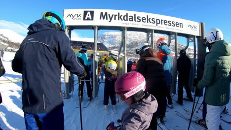 Long-waiting-line-for-skiers-to-enter-the-ski-lift-in-Myrkdalen-Norway---Handheld
