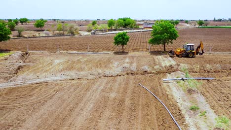 Cinematic-follow-shot-of-heavy-duty-excavation-machine-at-Indian-agricultural-land